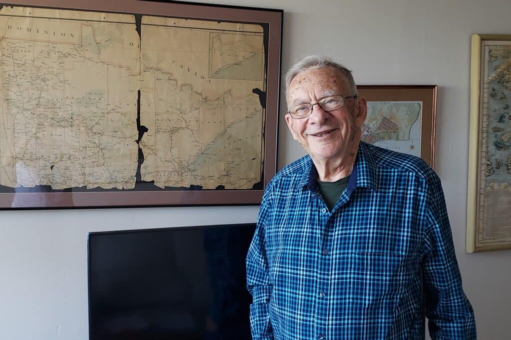 David Johnson standing in front of maps