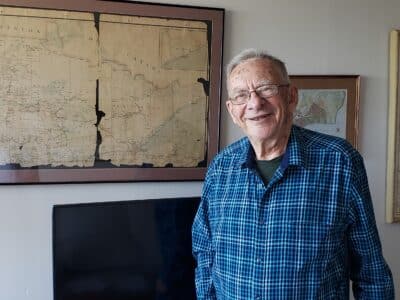 David Johnson standing in front of maps