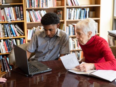 Graham Bennett, 14, teaches Riki Jursik, right, how to use her laptop.