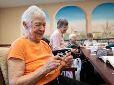 Residents at The Kenwood in Minneapolis knit scarves for children at a nearby elementary school on December 12, 2023.